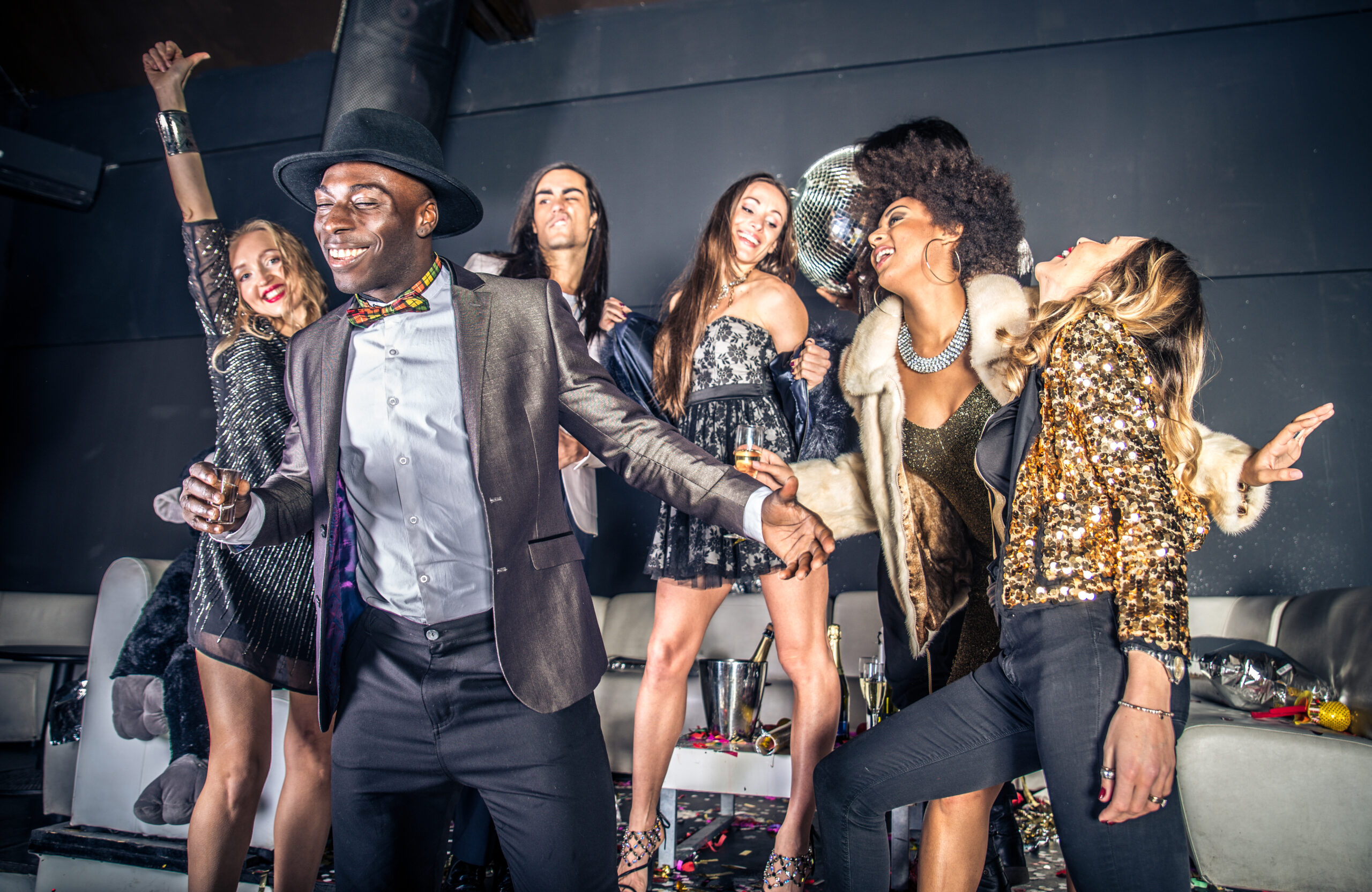 Multi-ethnic group of friends celebrating in a nightclub - Clubbers having party